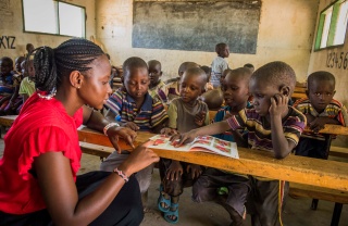 children in class listening attentively to their teacher