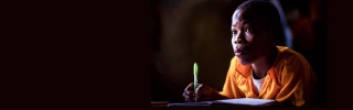 A child takes notes in class