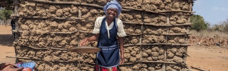 A Mary's Meals cook smiling in front of the camera.