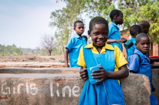 Girls eating Mary's Meals in Malawi